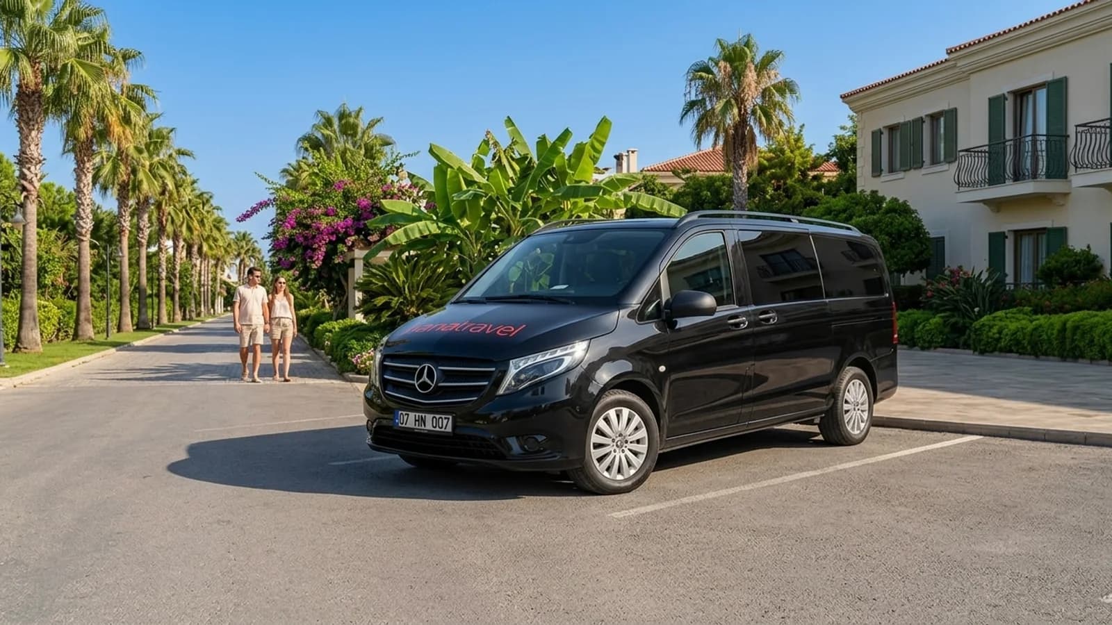 How an Antalya Airport Transfer Works: Step by Step A black transfer van parked beside a palm avenue during a private transfer in Antalya.
