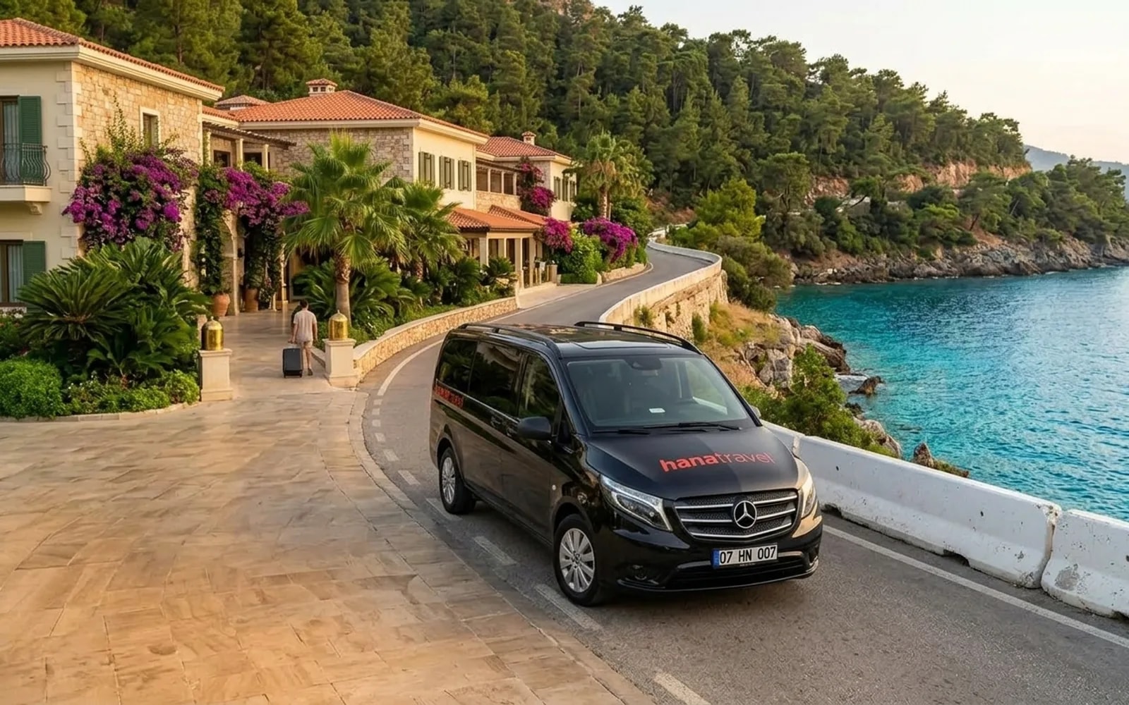 Only your party in the car Black Hana Travel Vito driving along a sunny coast road above turquoise water on the Antalya Riviera — Antalya private transfer